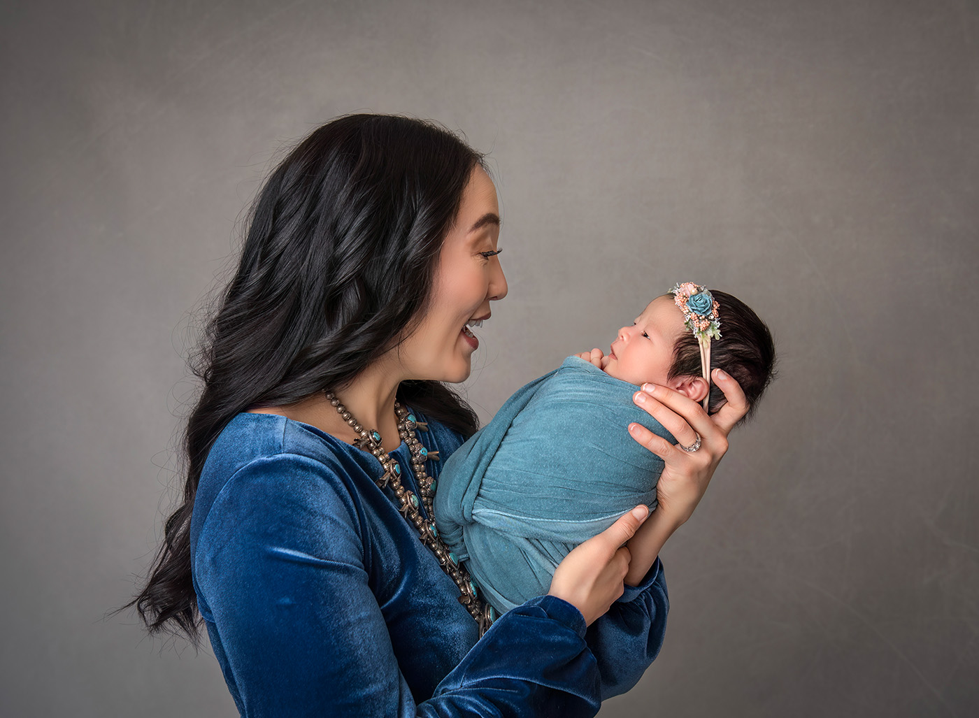 Luxury Newborn Photographer Mom smiling at newborn baby girl