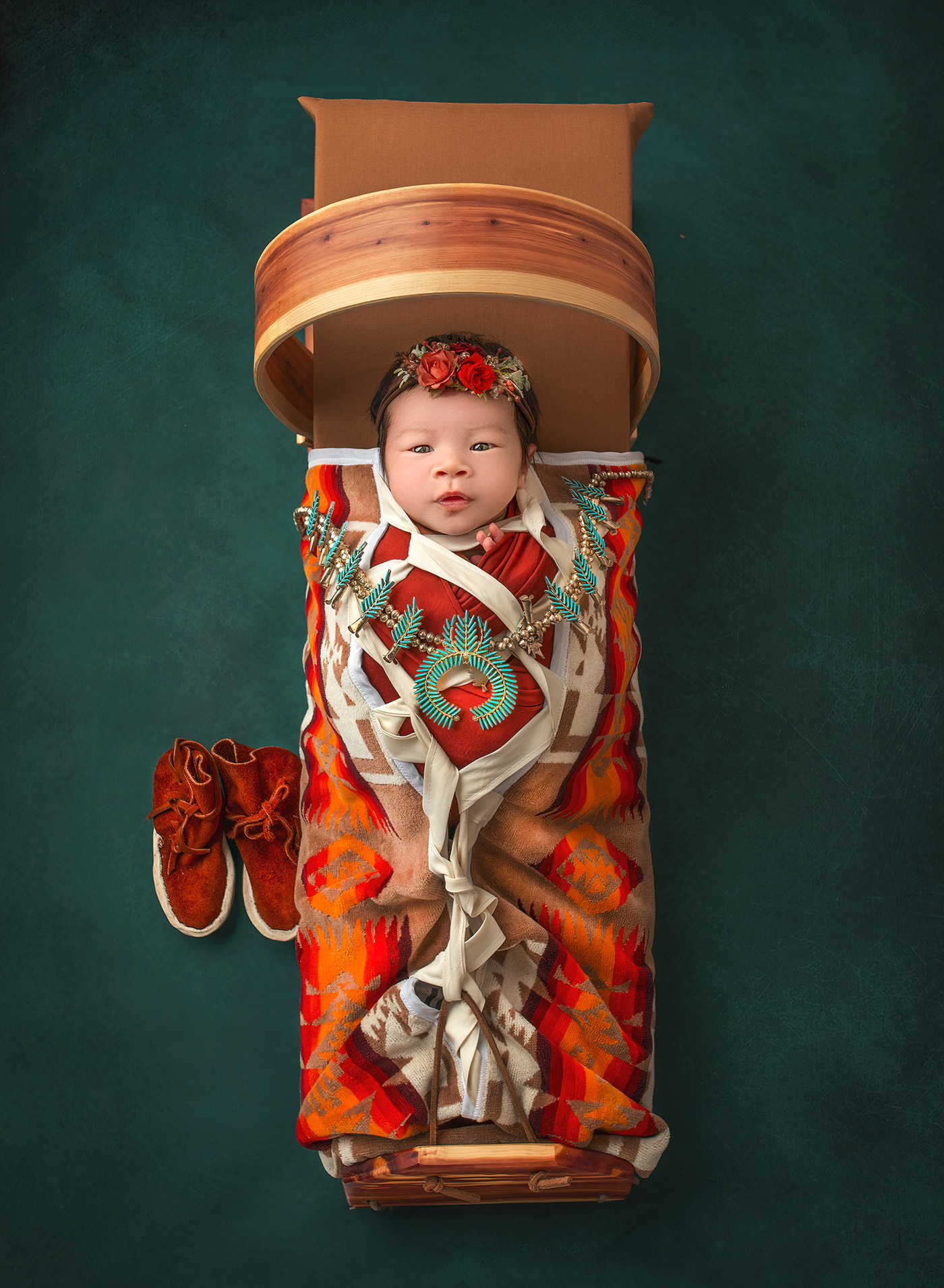 Luxury Newborn Photography newborn baby in Navajo craddle board with Navajo baby mocsasins and squash blossom jewelry