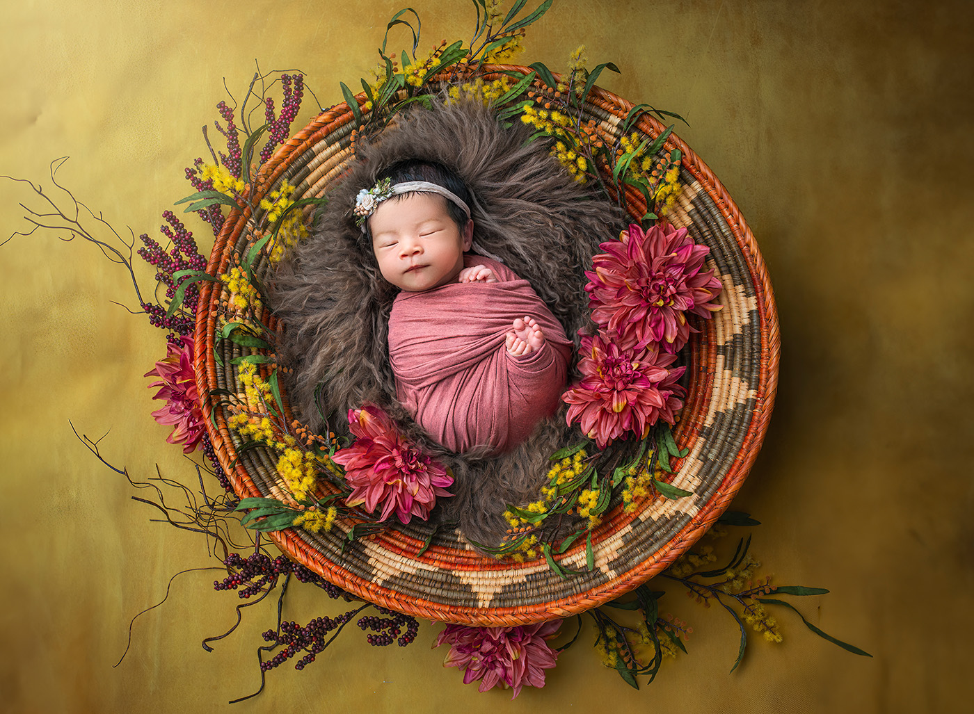 Luxury Newborn Photography newborn baby sleeping in a traditional Navajo wedding bowl