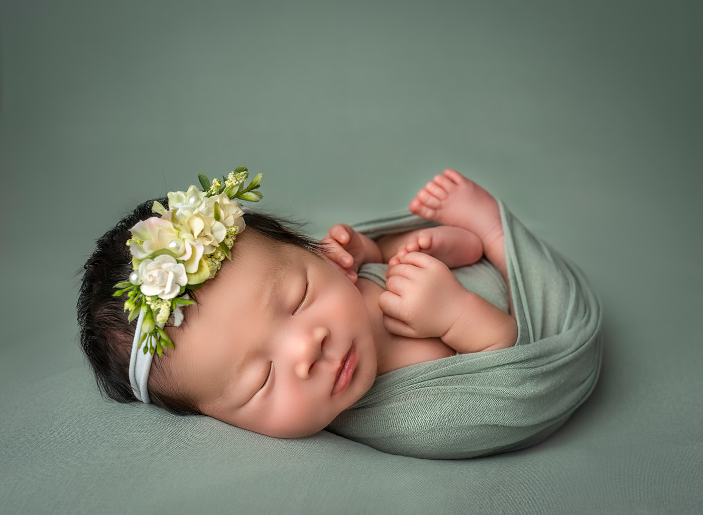 Luxury Newborn Photography simple photo of newborn baby girl sleeping wrapped on green fabric