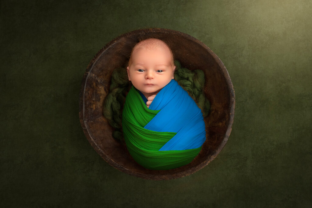 best time to do newborn photoshoot little boy wrapped as the world