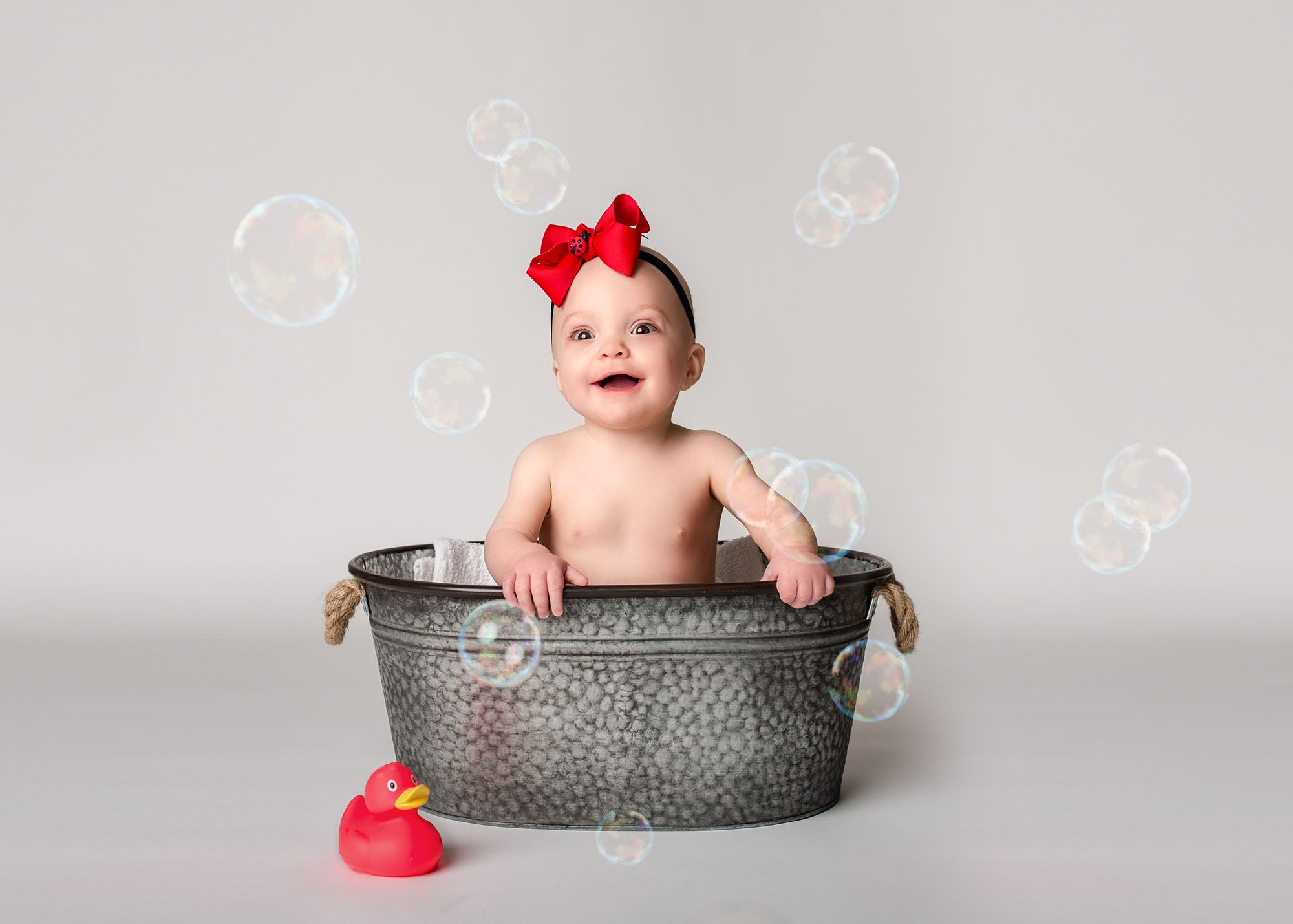 baby girl with red boy taking a bubble bath in a tin tub with a red rubber duck Glastonbury CT Baby Photographer One Big Happy Photo www.onebighappyphoto.com/babies