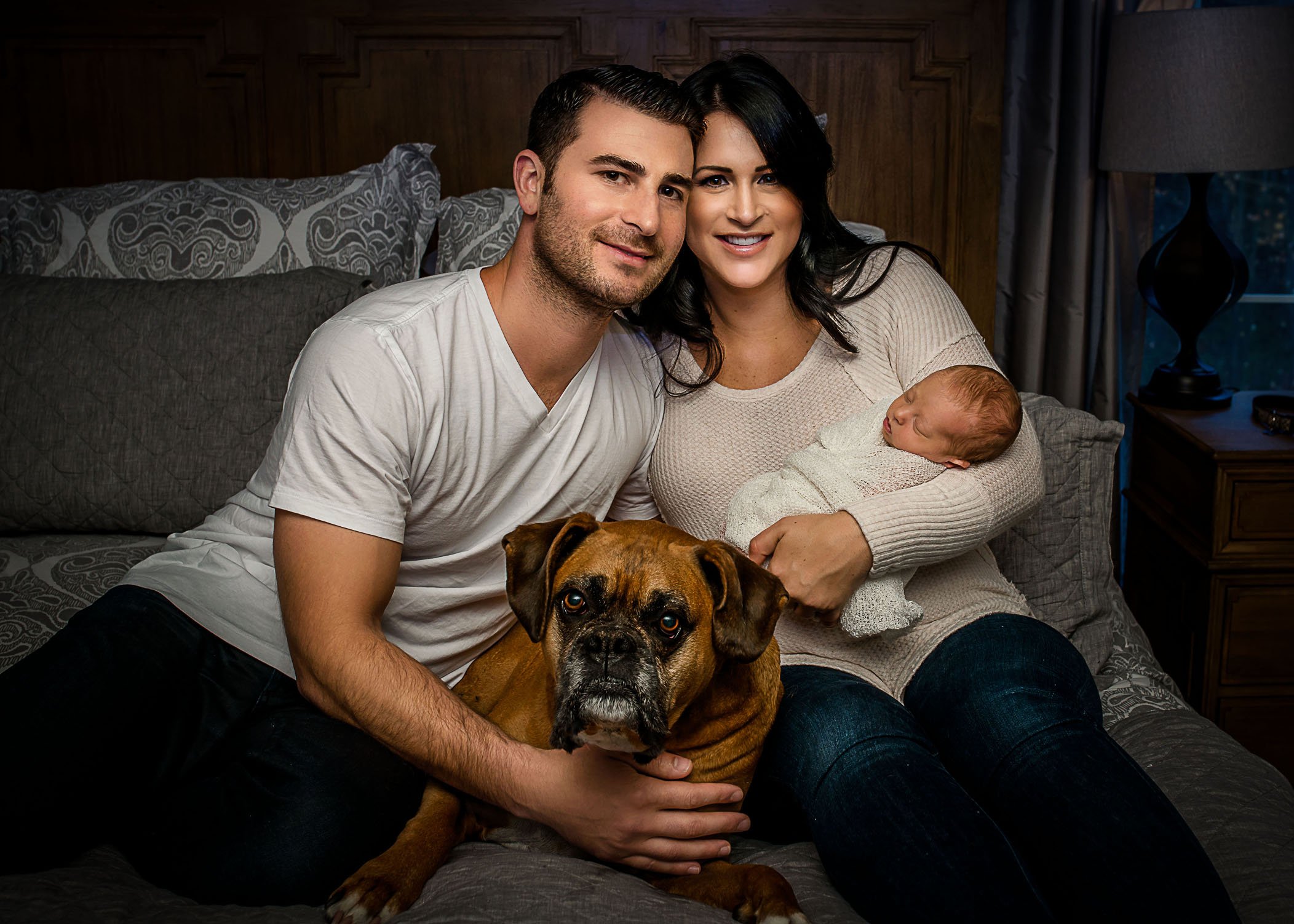 New mom and dad with their dog and newborn baby girl