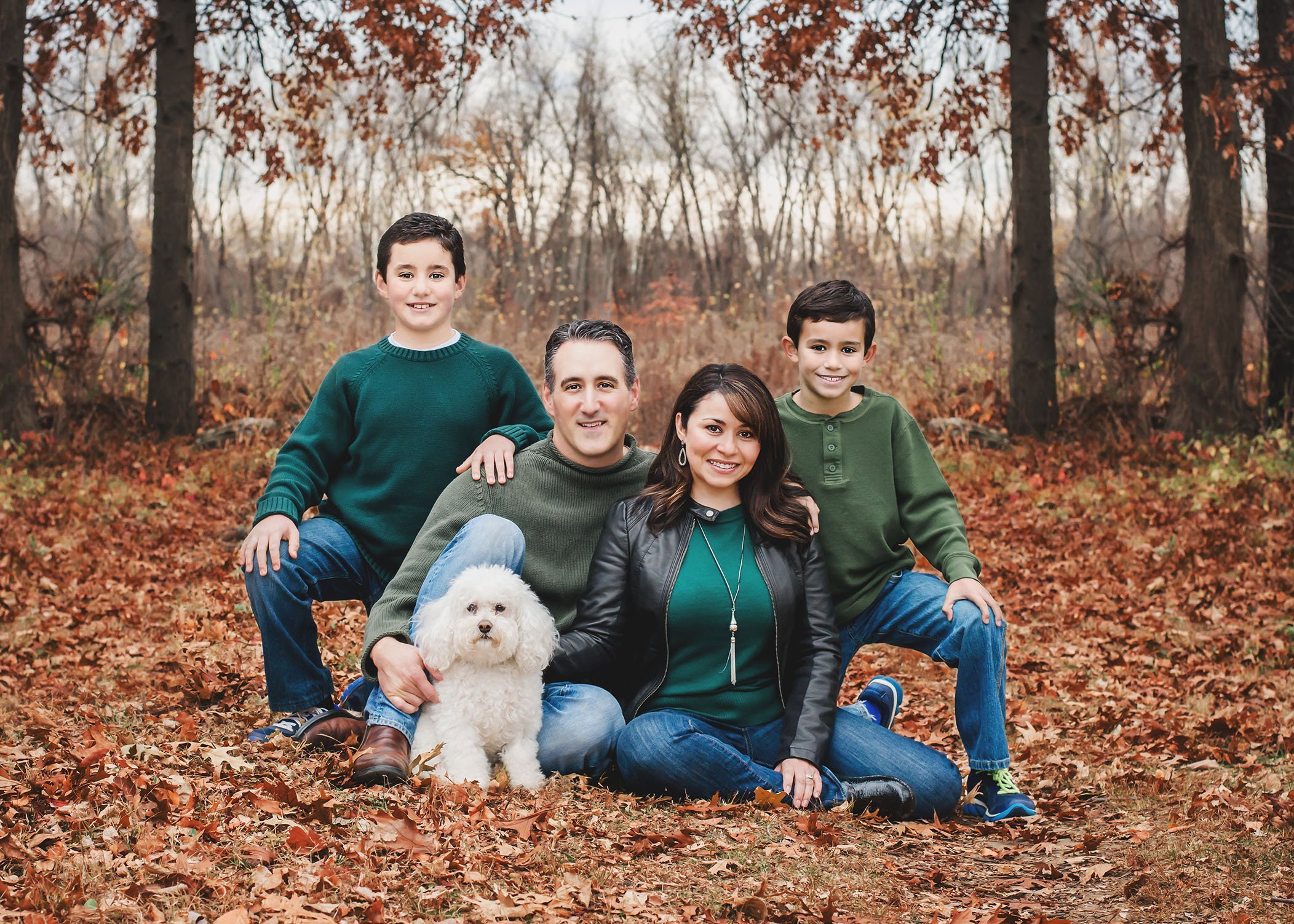 Family of four photo in Fall with their white small dog