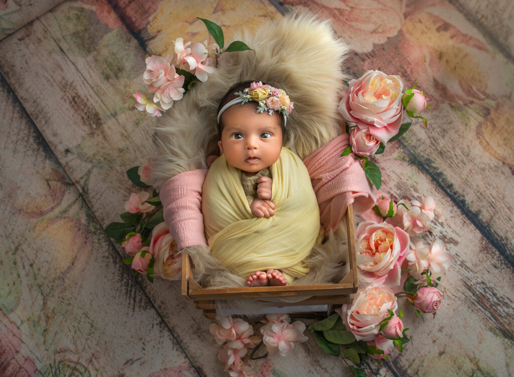 best time for a newborn shoot awake baby girl surrounded by roses