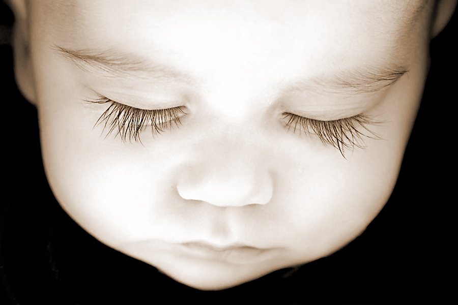 Sleeping newborn baby with long eyelashes