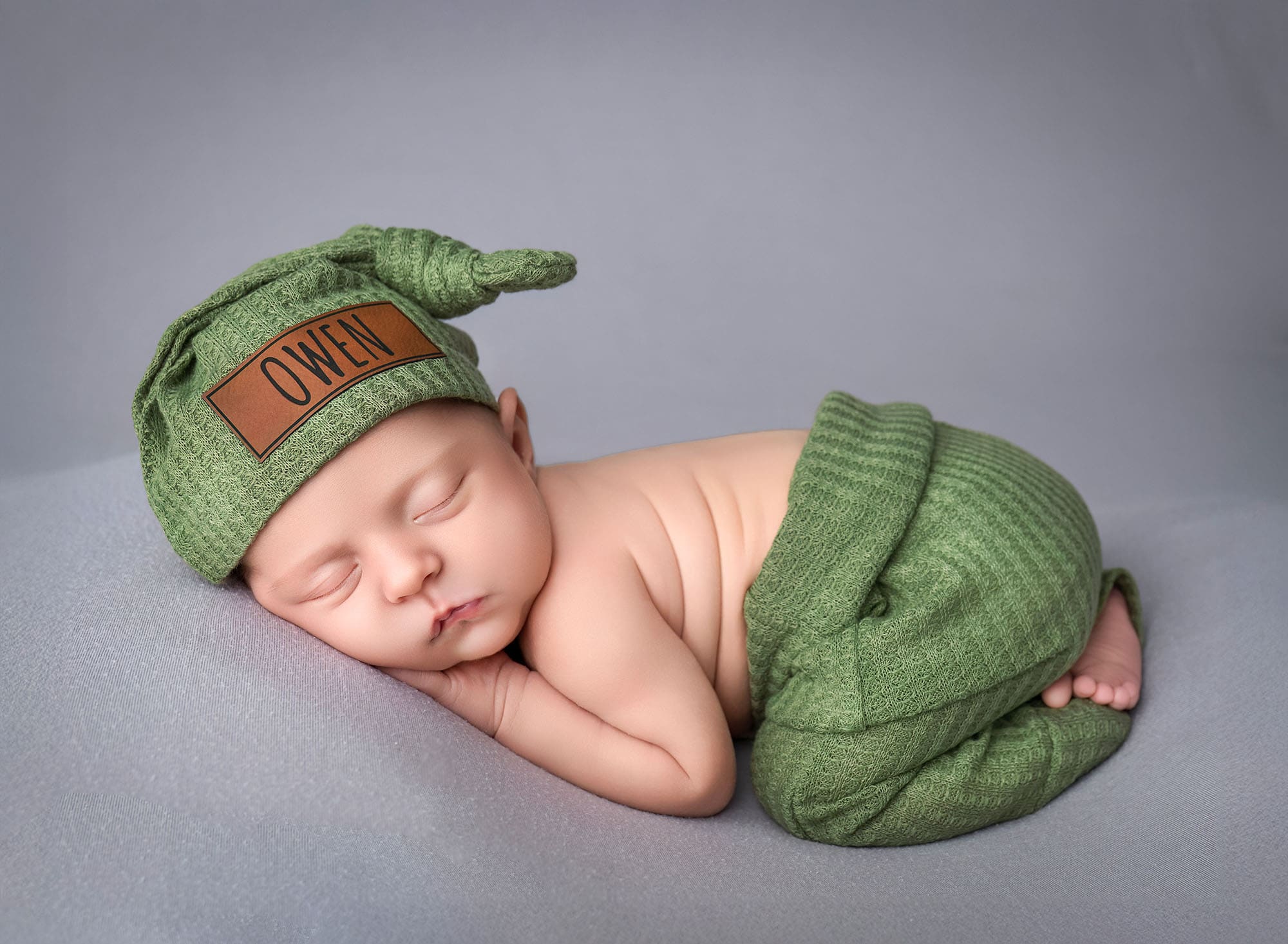 newborn photography ct baby sleeping on his tummy with a hat
