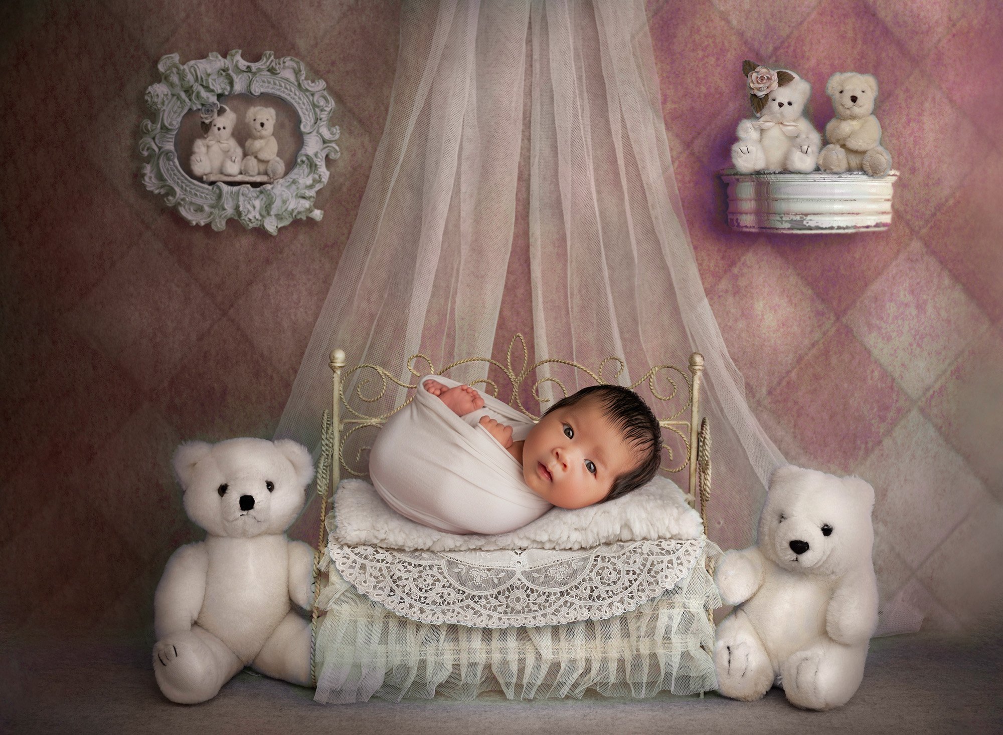 awake newborn baby girl laying in miniature princess bed surrounded by stuffed animal bears on a pink diamond background