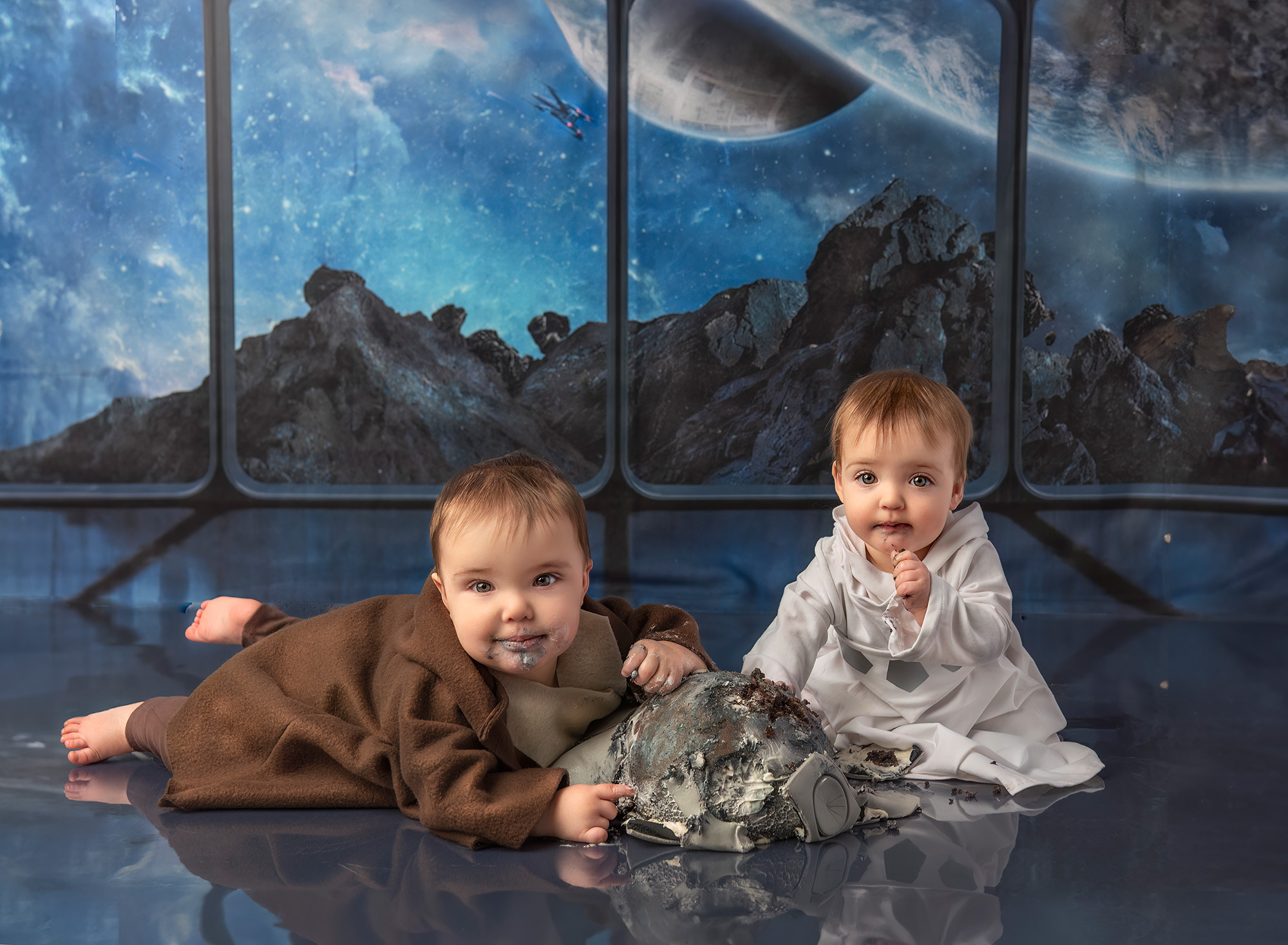 Twin boy and girl eating Star Wars cake in front of a Star Wars background