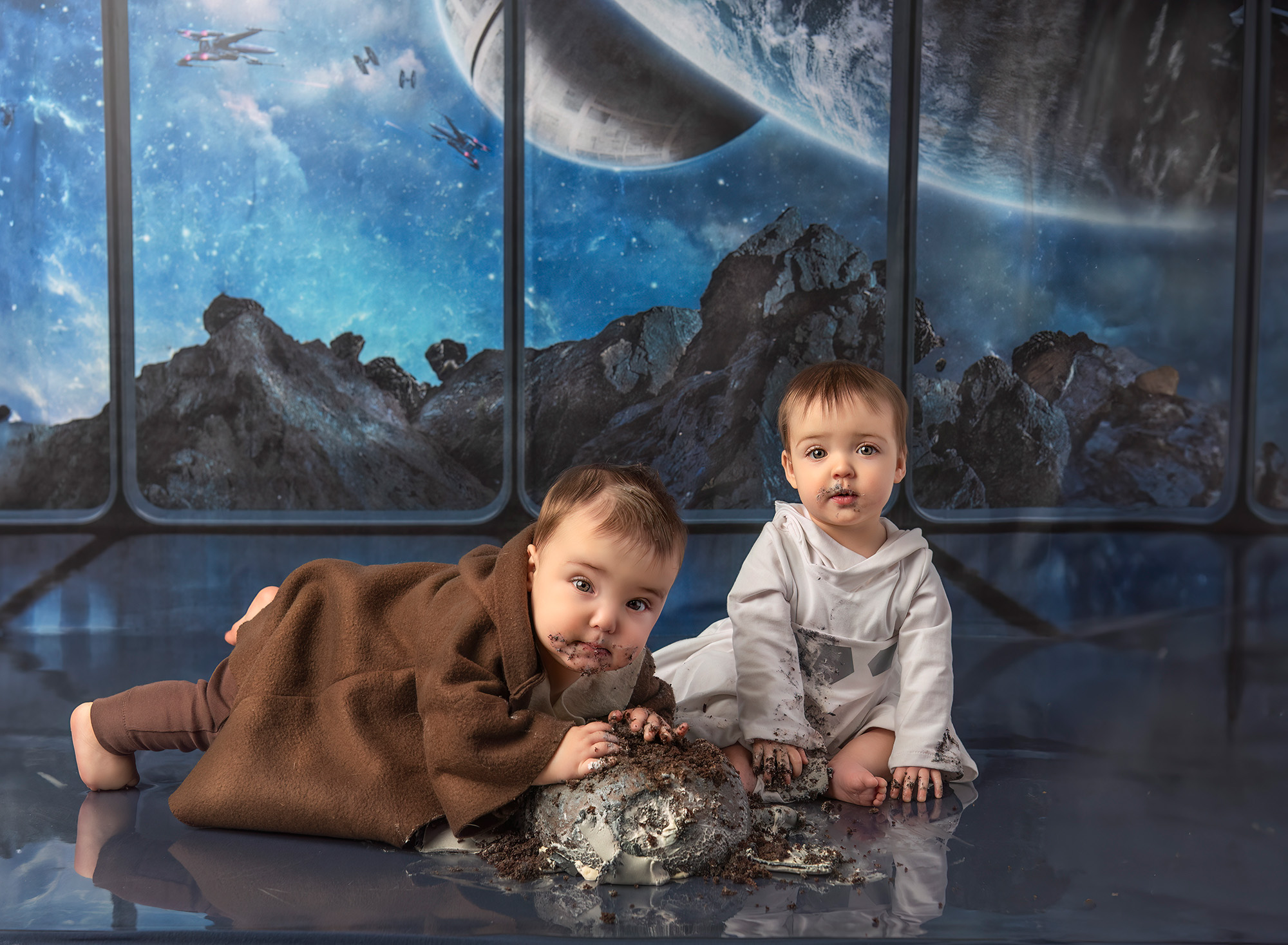 Twin Photo Shoot Star Wars Cake Smash Twin boy and girl eating Star Wars cake in front of a Star Wars background