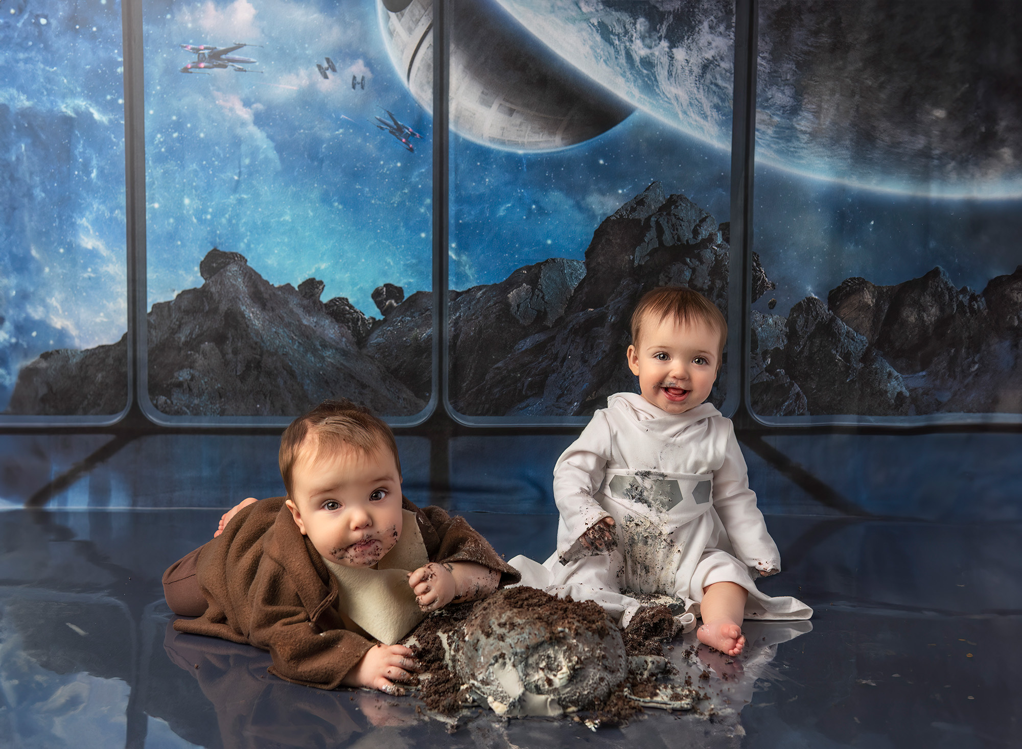 Twin boy and girl eating Star Wars cake in front of a Star Wars background