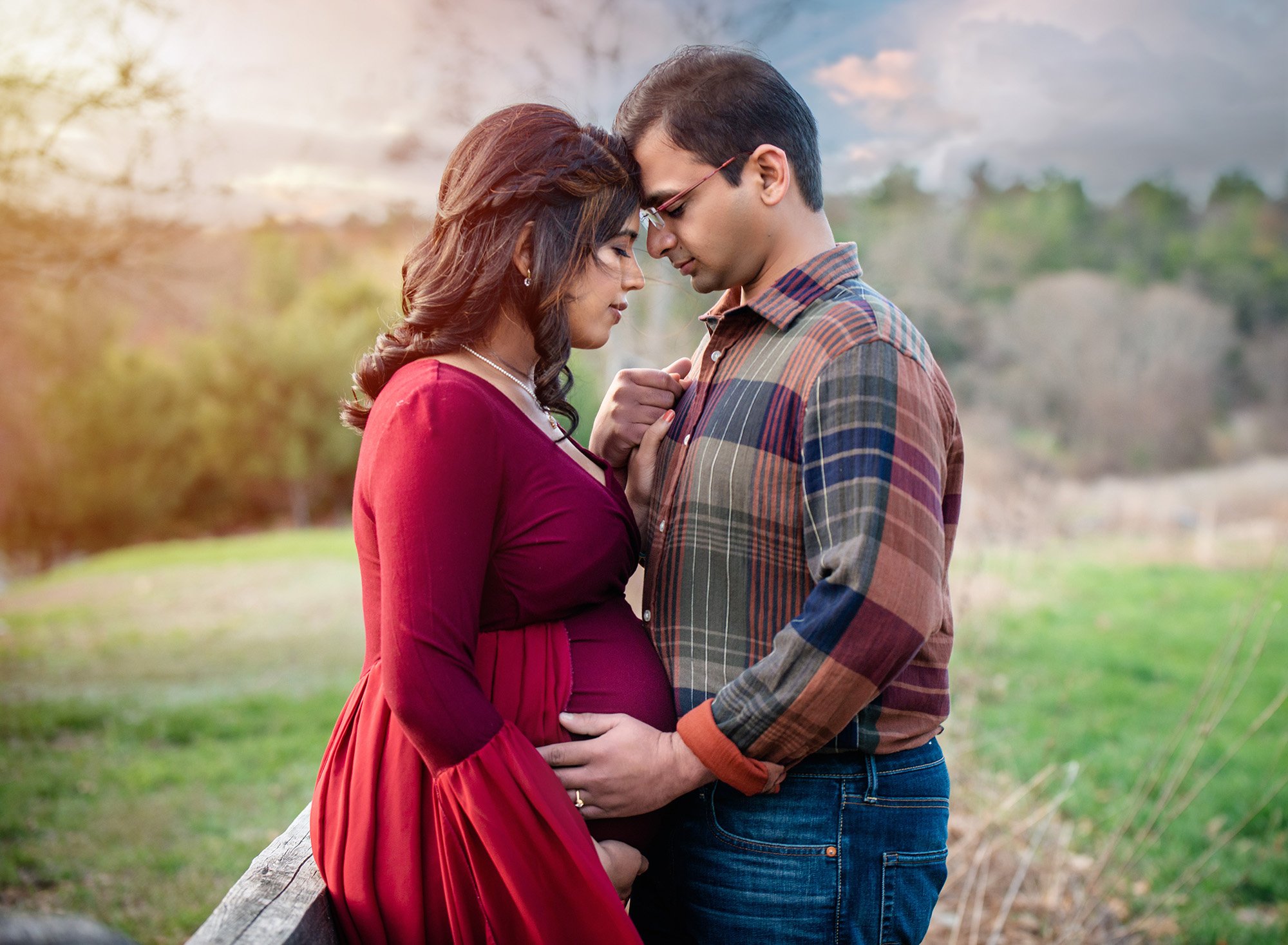 pregnant woman posing with partner outdoors in the winter