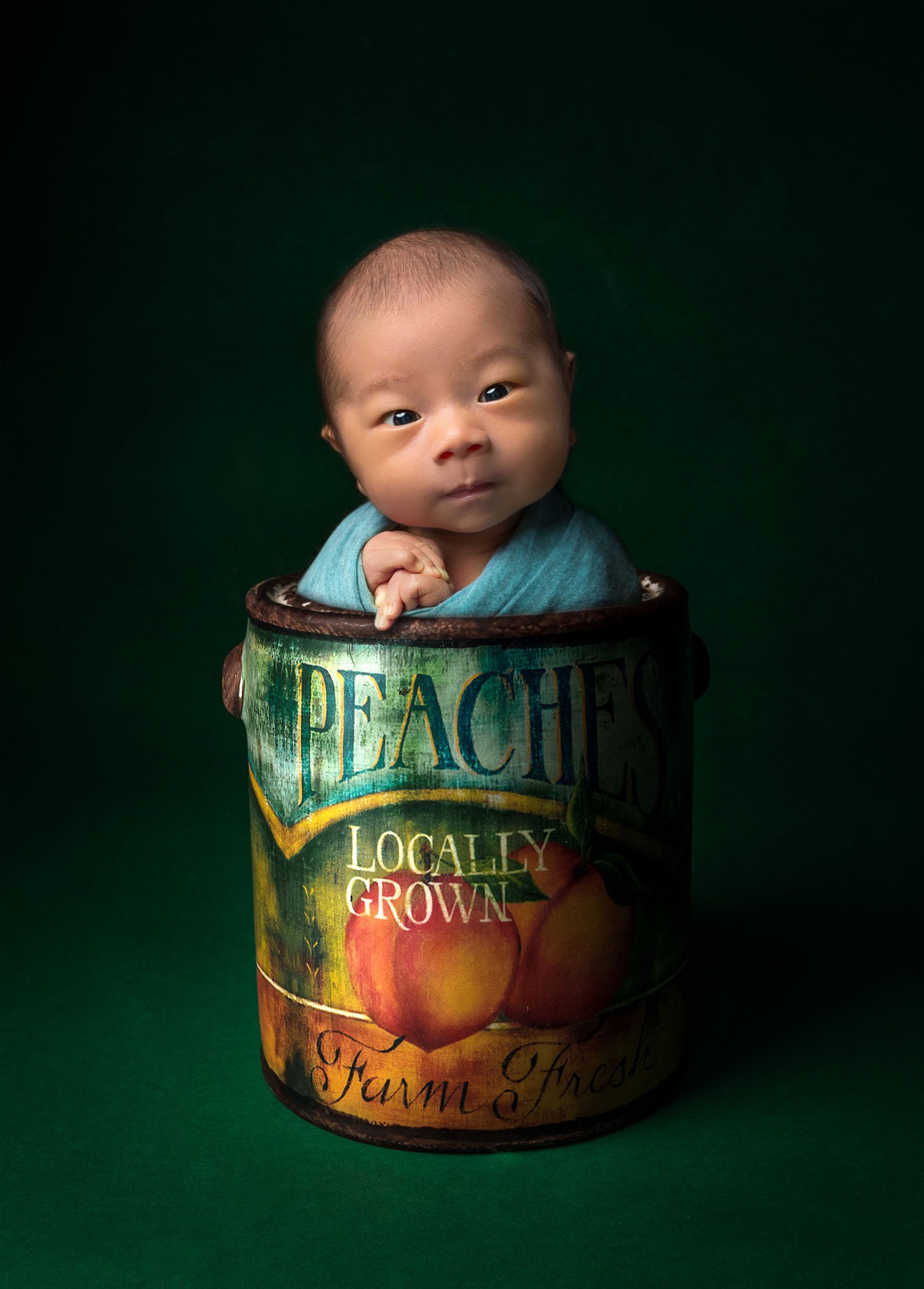 creative newborn photos newborn baby awake in can of peaches prop