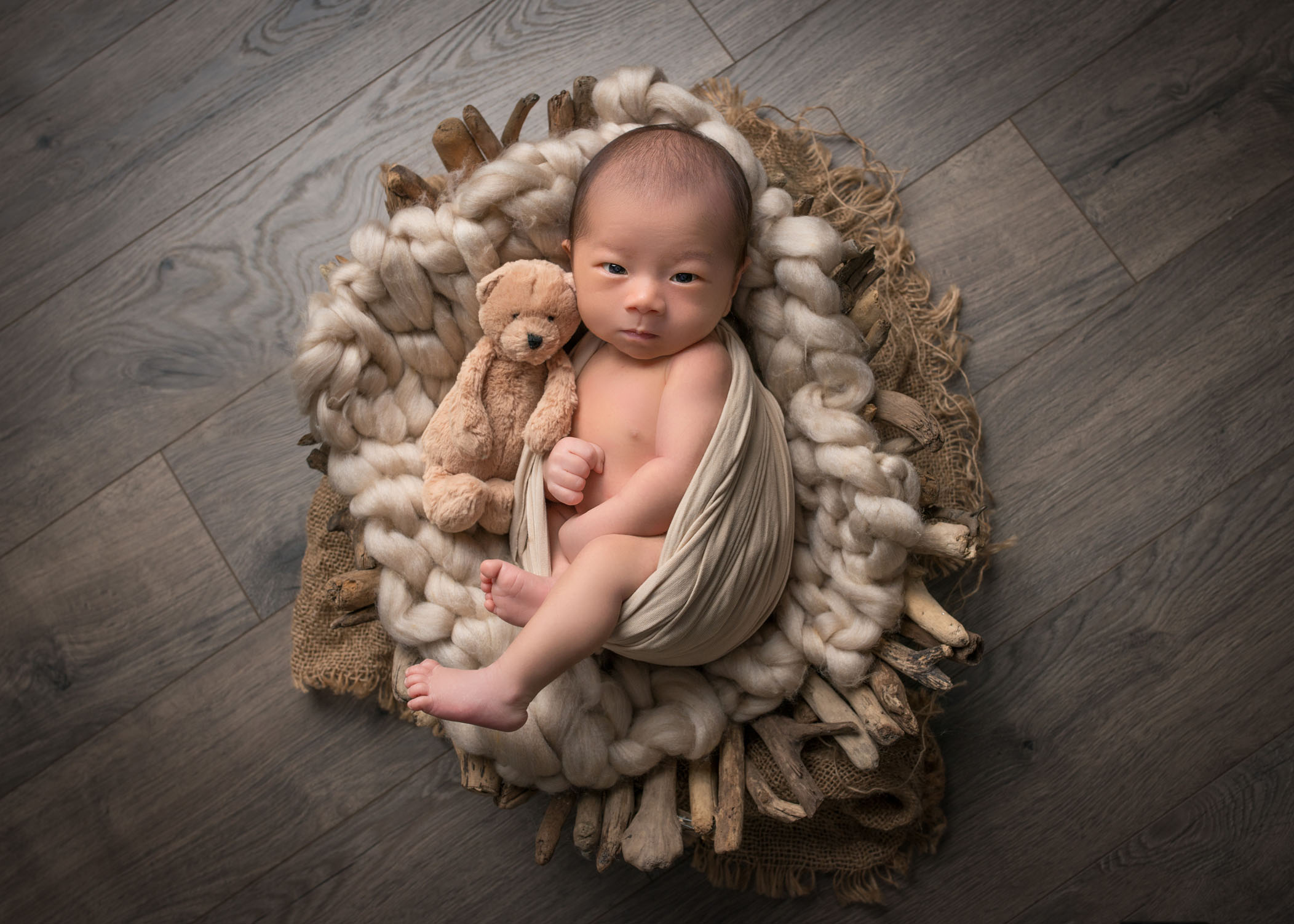 adorable newborn photos newborn baby boy swaddled in wooden basket with stuffed bear