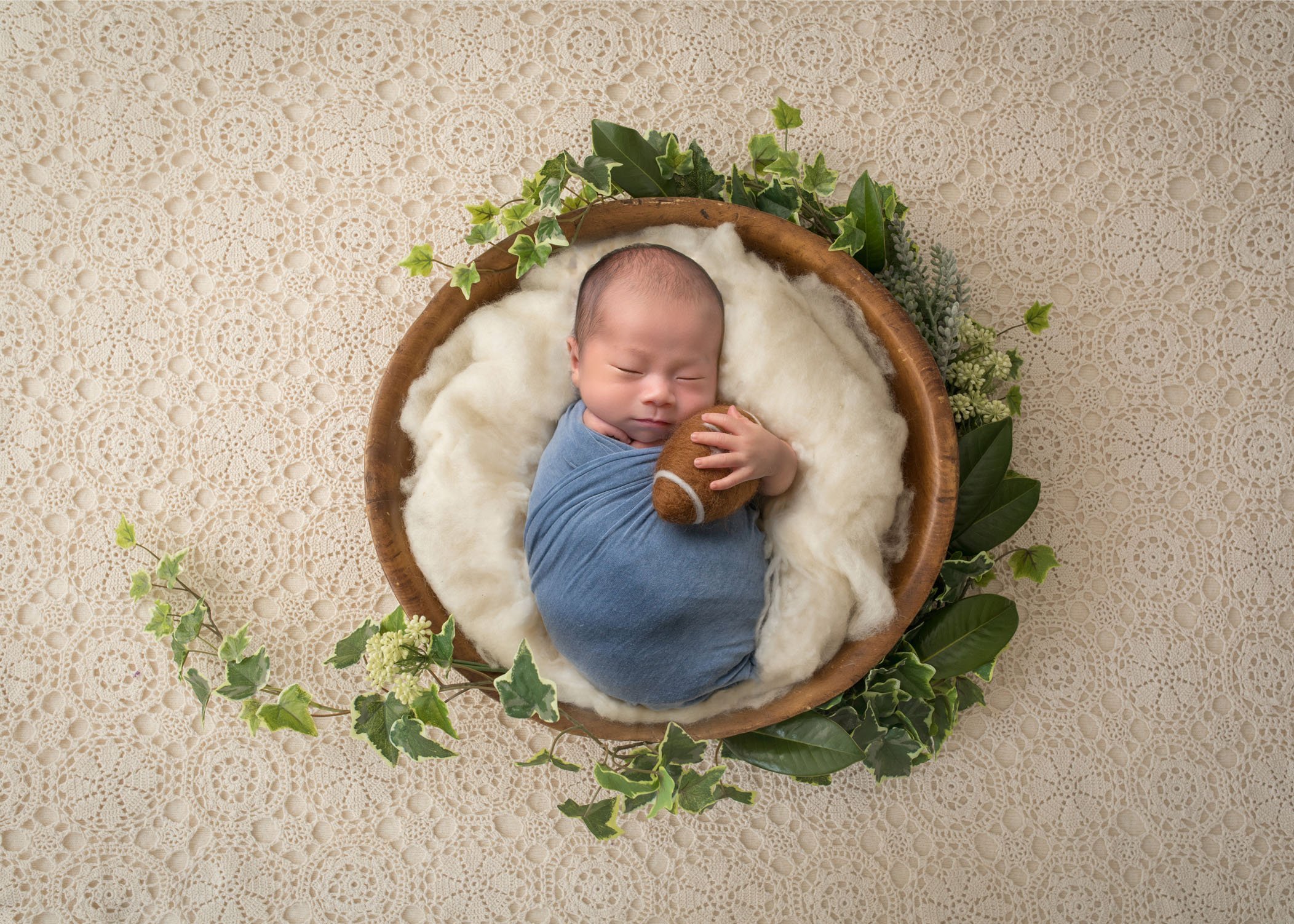 adorable newborn photos Chinese newborn baby boy sleeping in bowl with a felted football