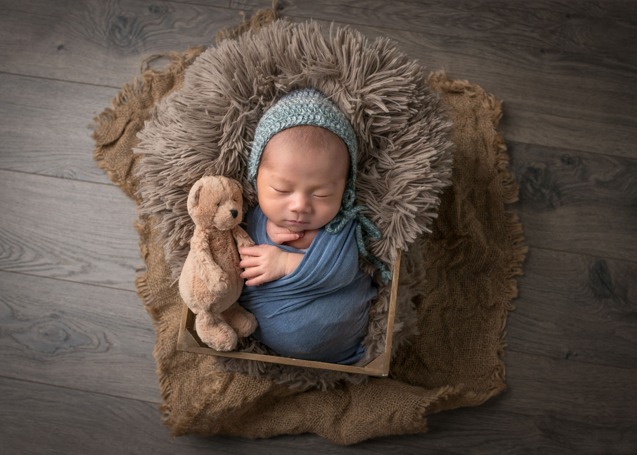 adorable newborn photos Chinese newborn baby boy sleeping in crate with his stuffed bear