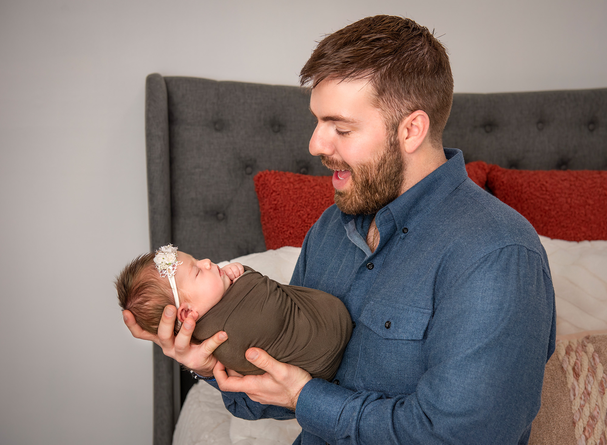 best newborn photography dad holding baby and reacting to her cute noises