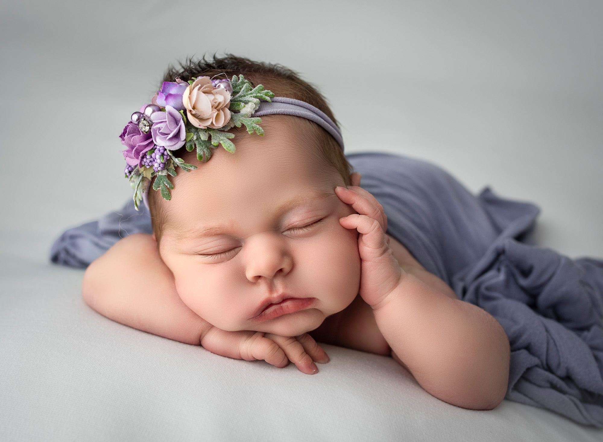 best newborn photography newborn baby sleeping with her head on her hands with one hand resting on her cheek