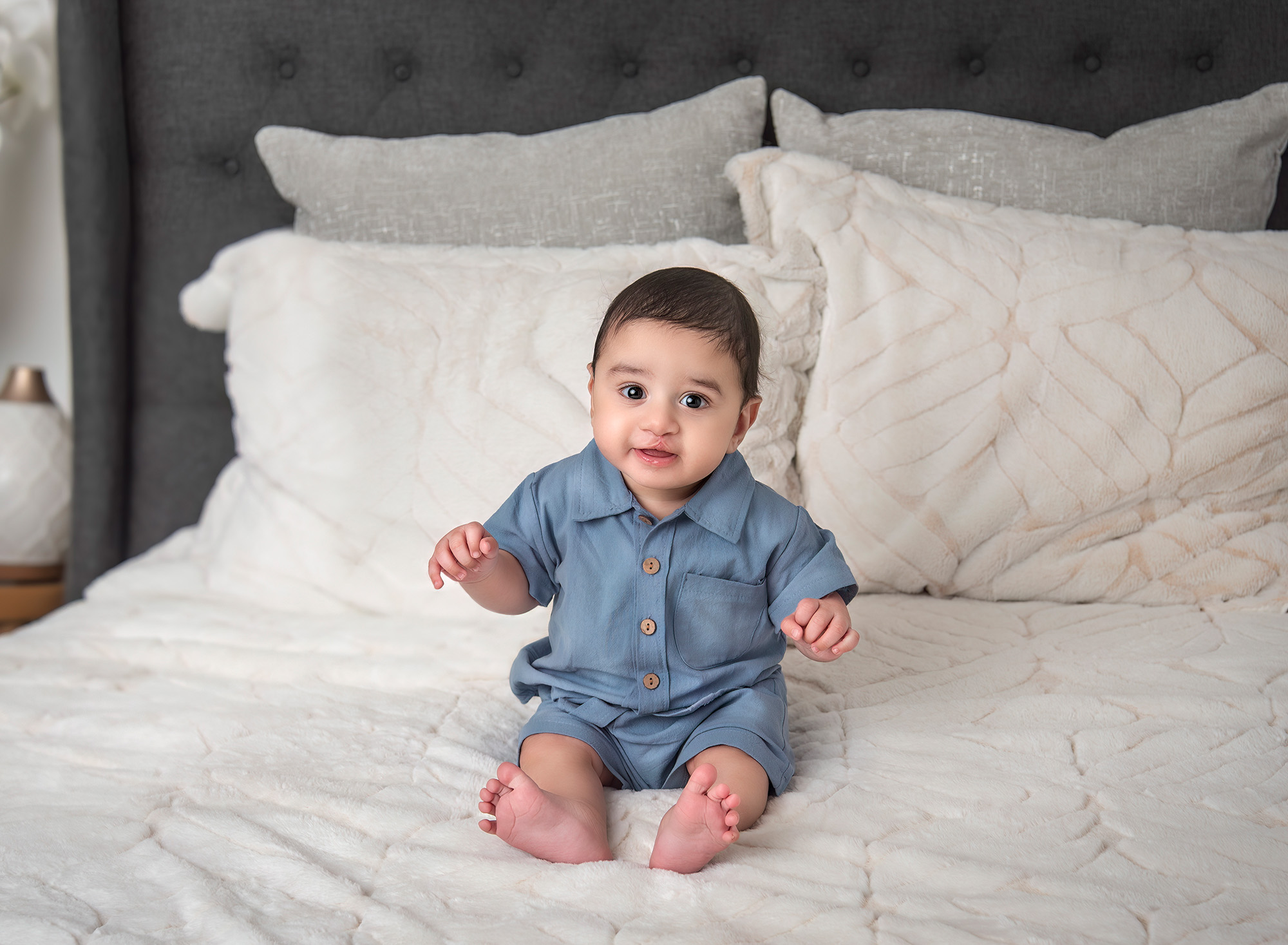 Three month old smiling on the bed