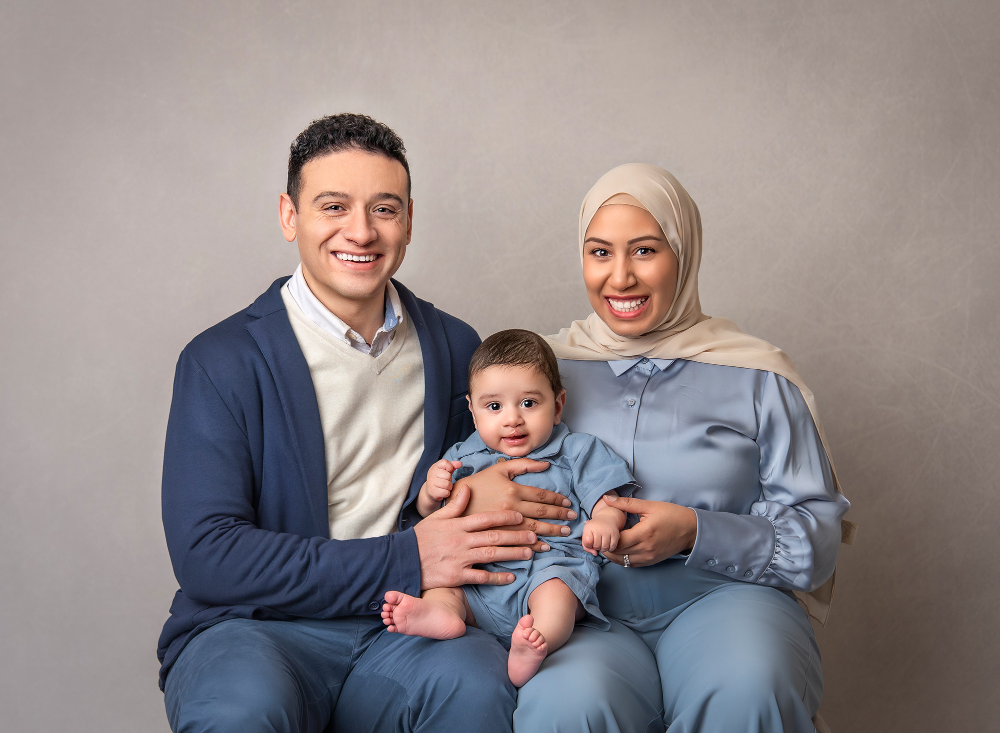 Family portrait of three, smiling