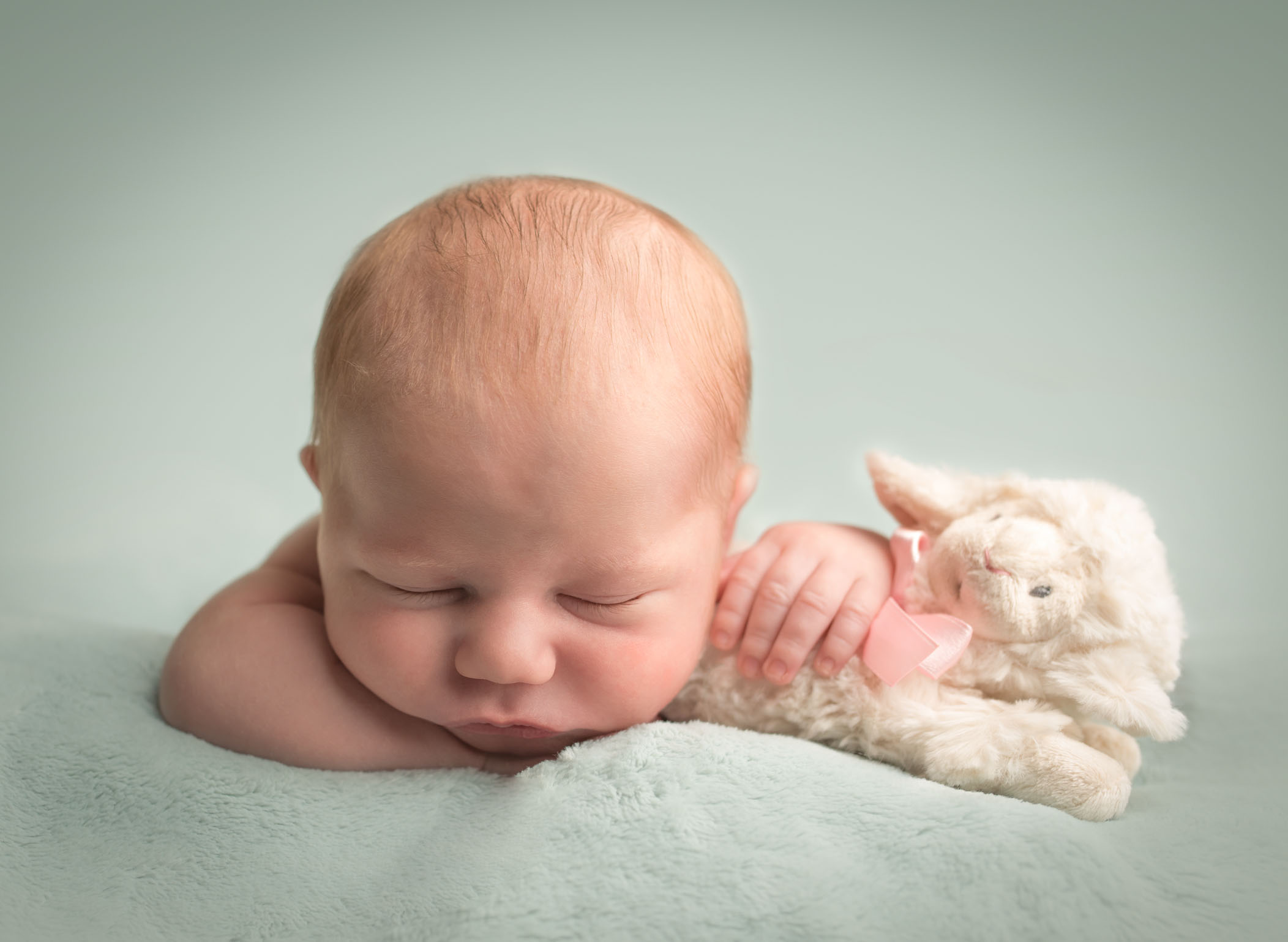 rainbow newborn baby boy holding sister's lamb