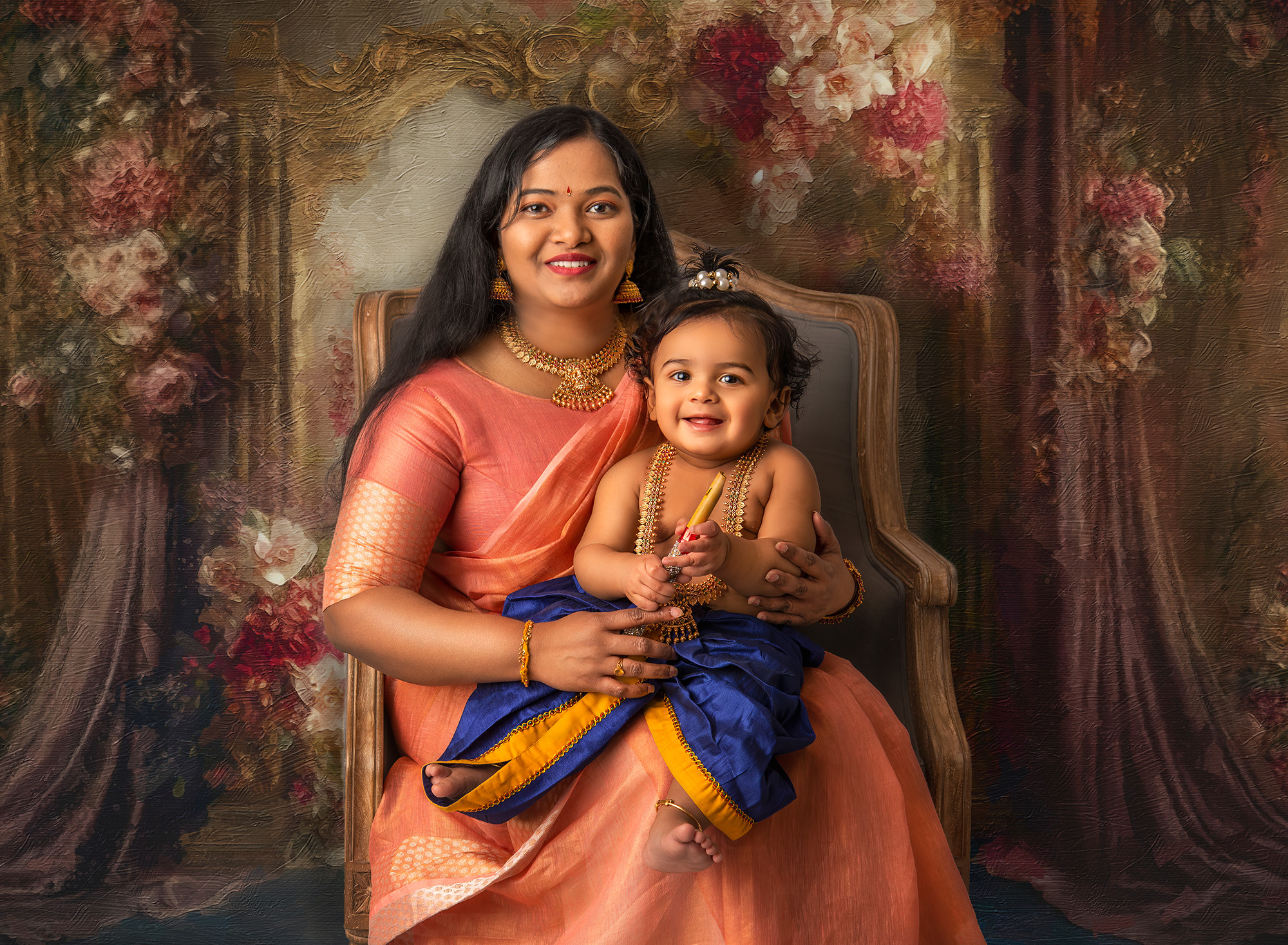 in studio family photos indian mom dressed in traditional indian attire holding her 1 year old son dressed as baby Krishna