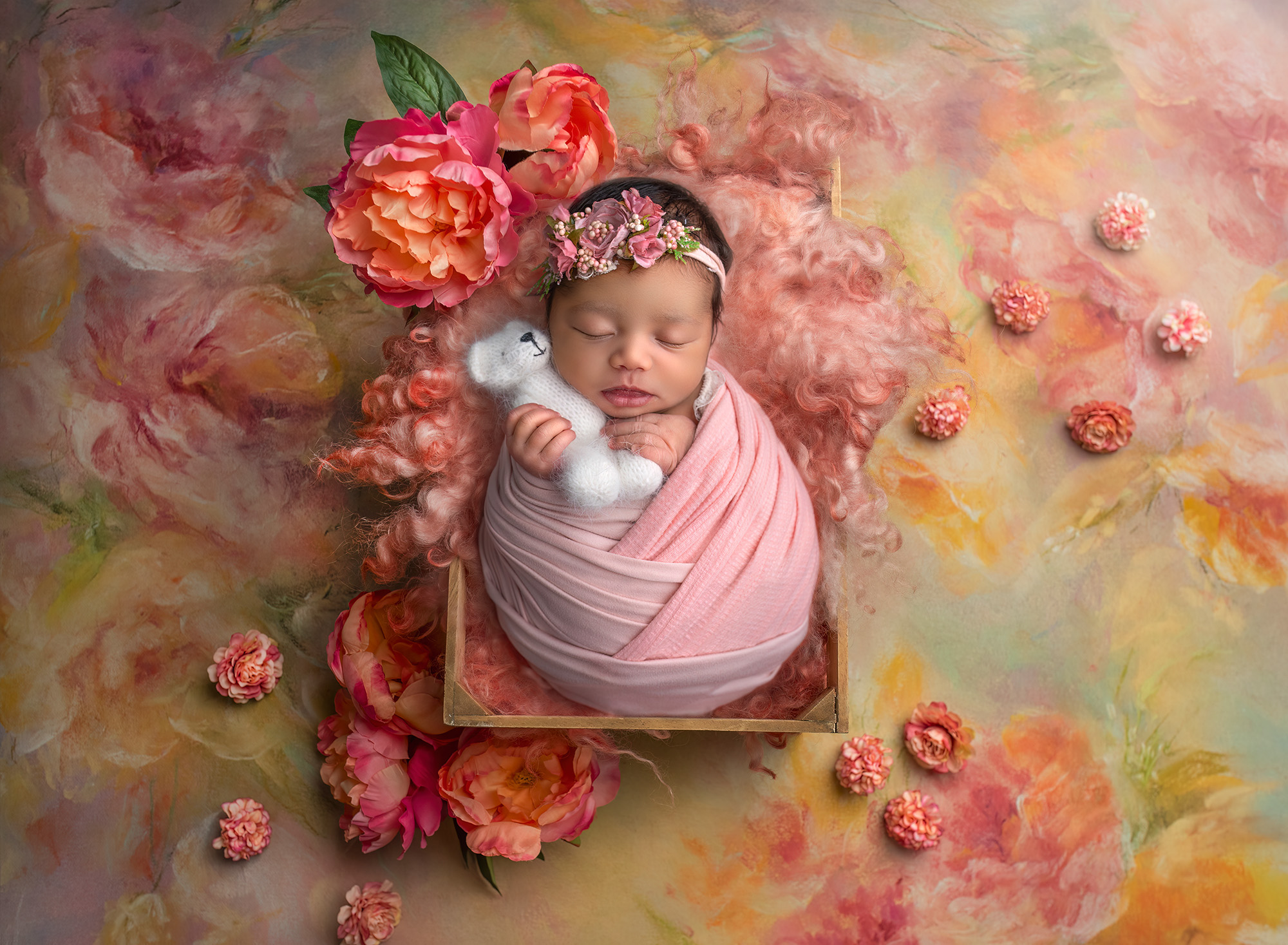 newborn baby girl sleeping in a crate holding a white teddy bear surrounded by antique florals