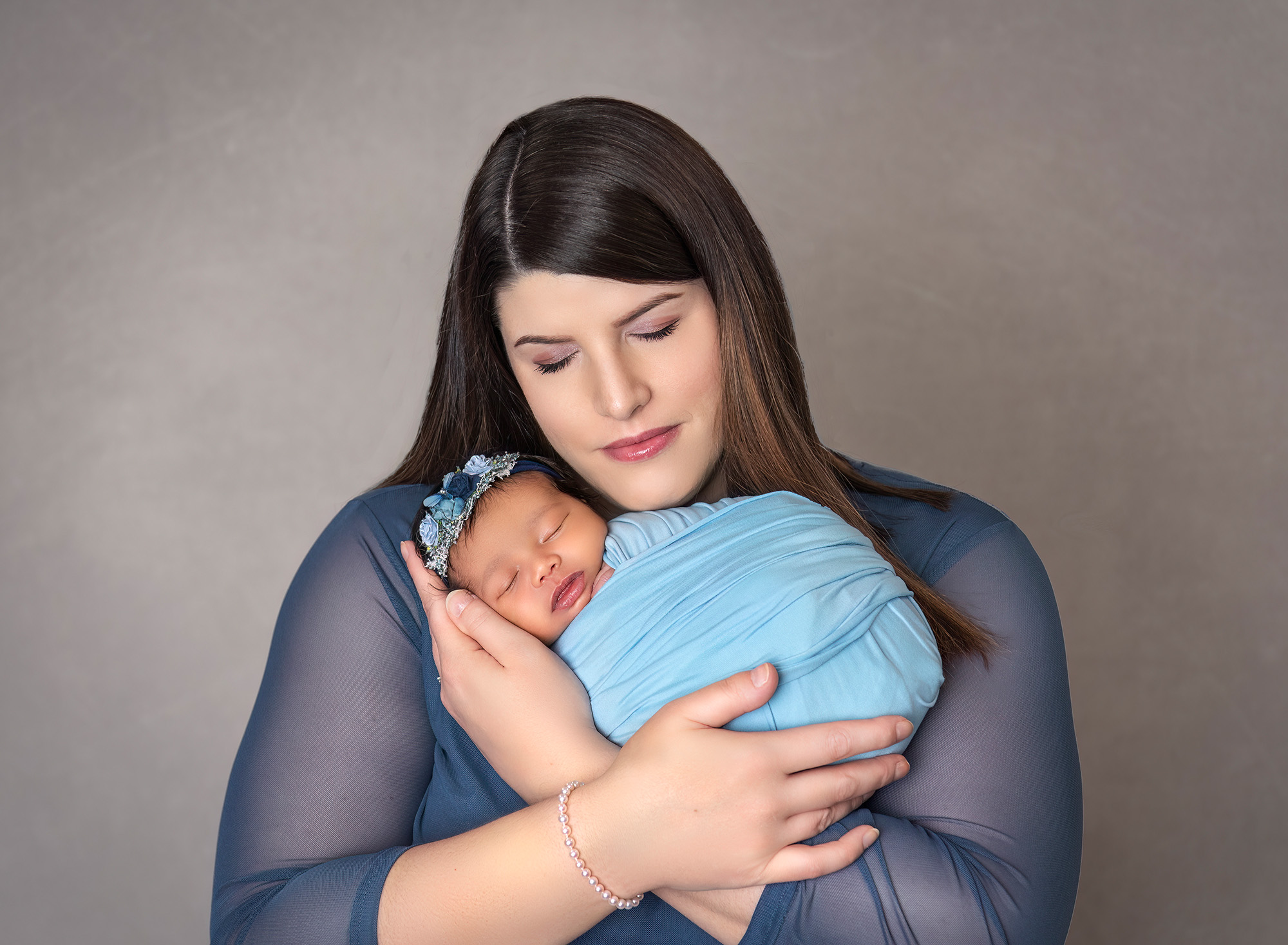 Mom cradling newborn baby girl