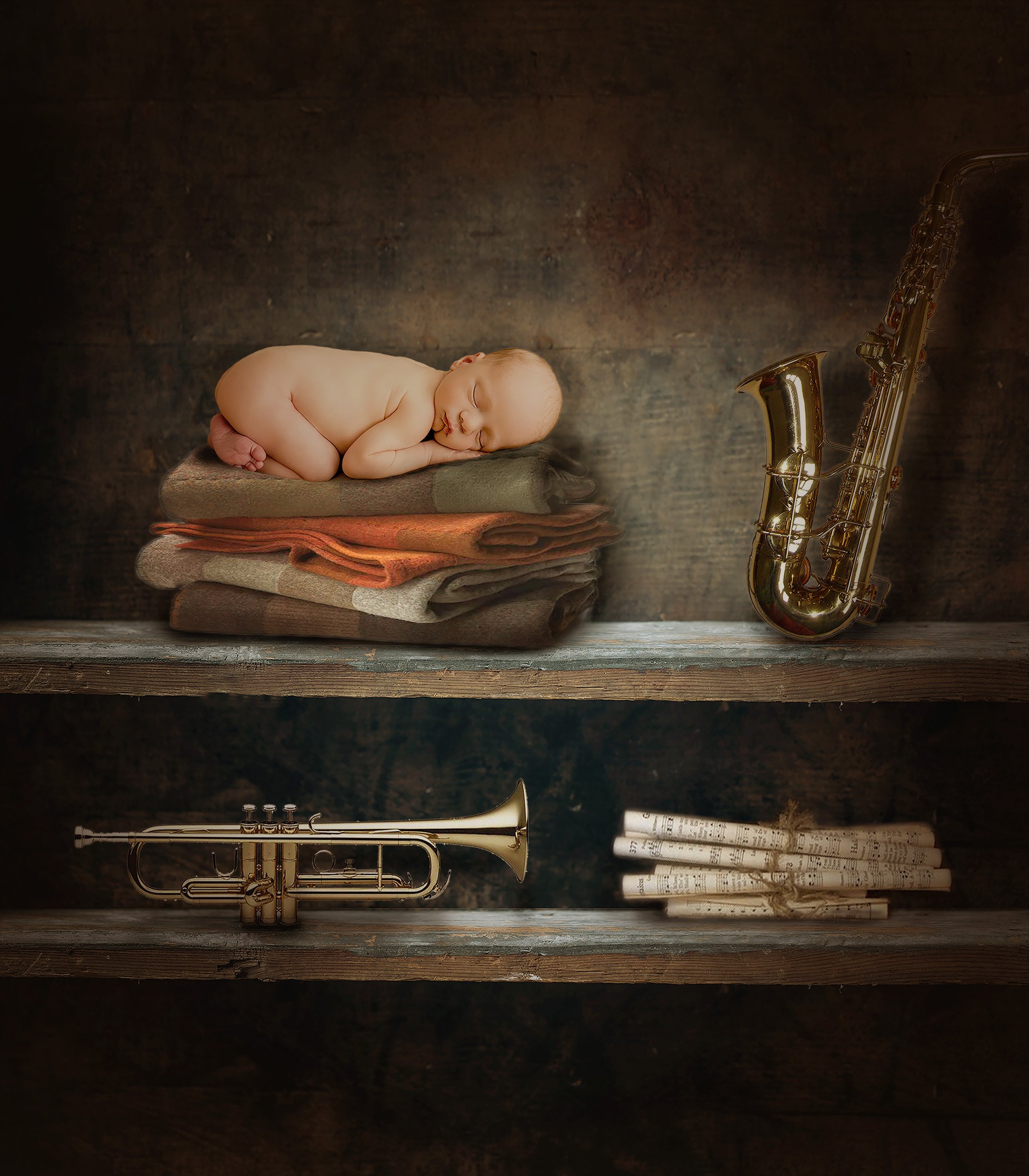 Newborn baby sleeping on a pile of blankets near a trumpet saxophone and rolls of music