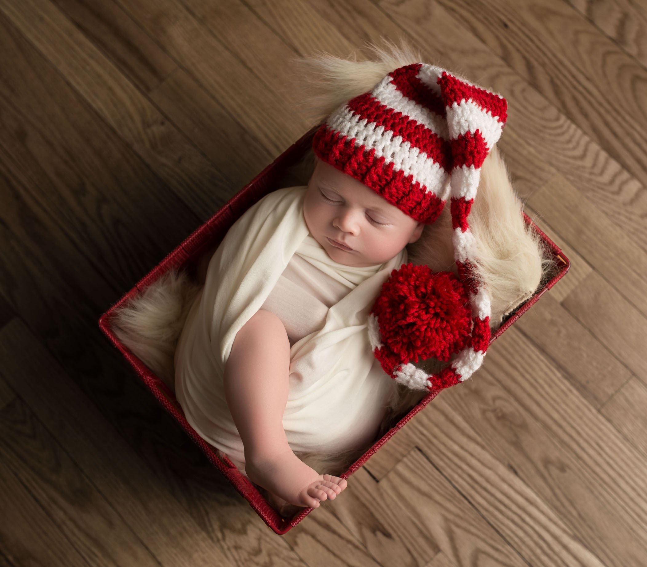 newborn baby in Dr. Suess striped hat