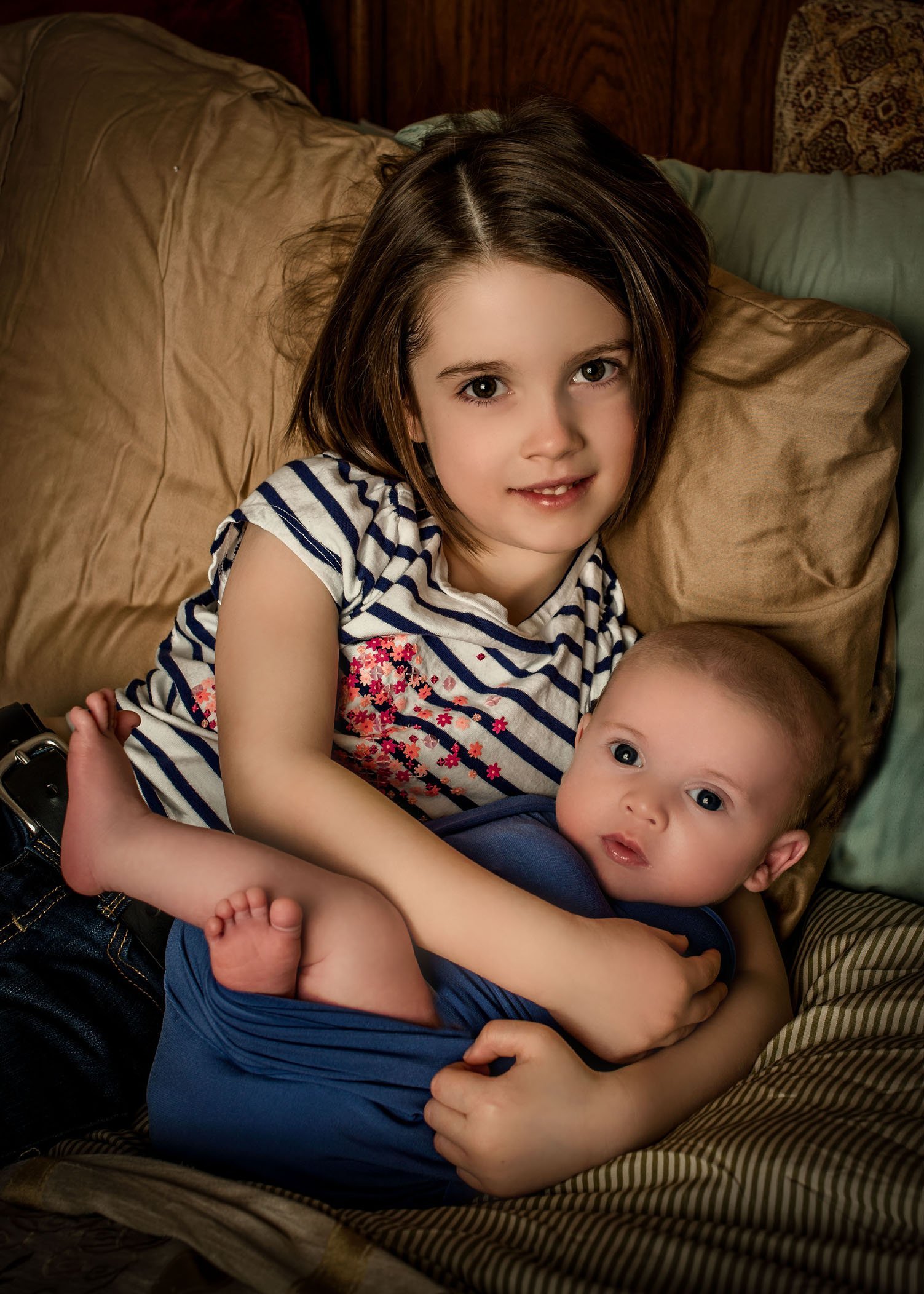 big sister holding baby brother