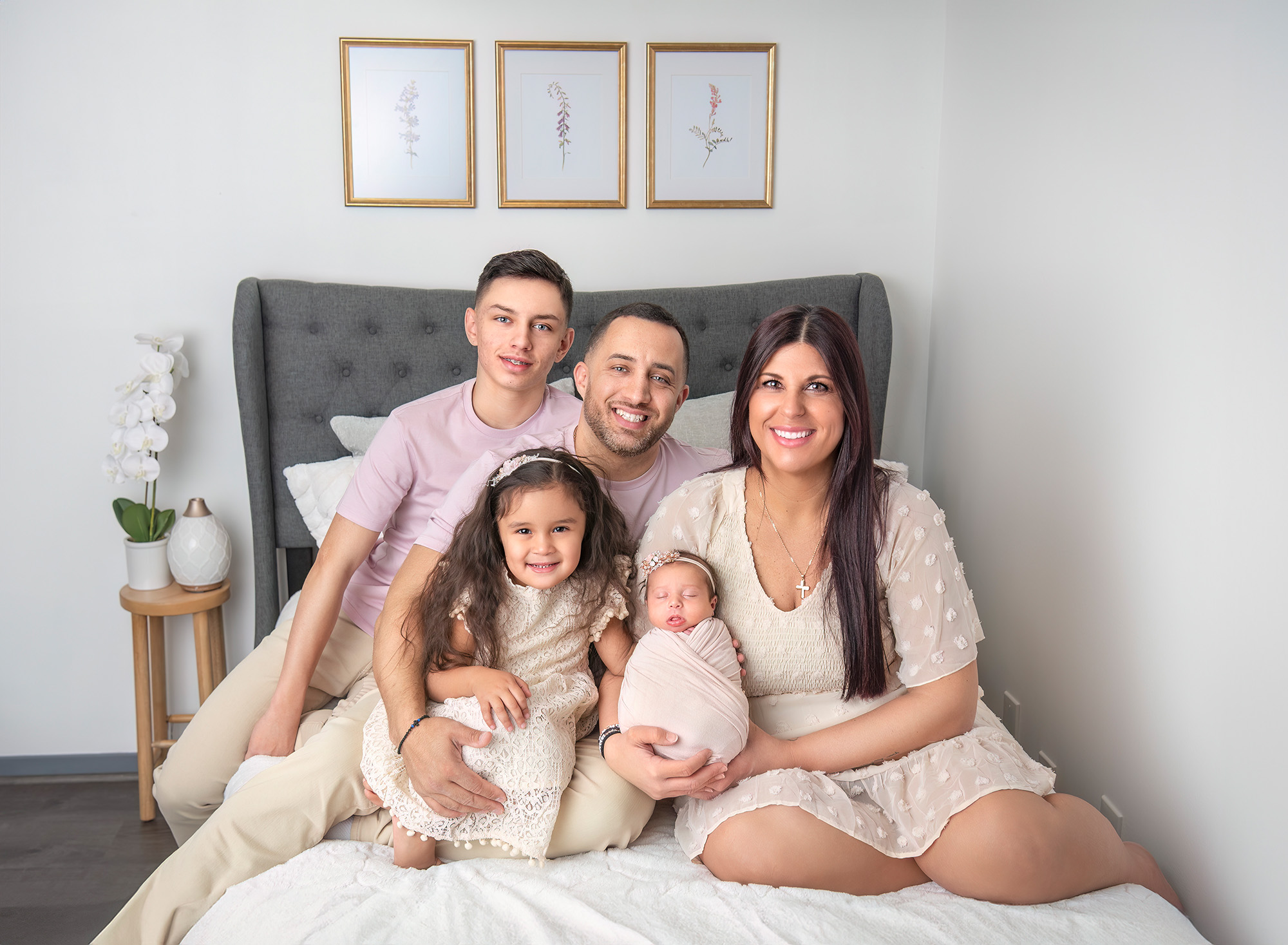 Newborn Maternity Photographer lifestyle portrait of family of five with their new baby sister.