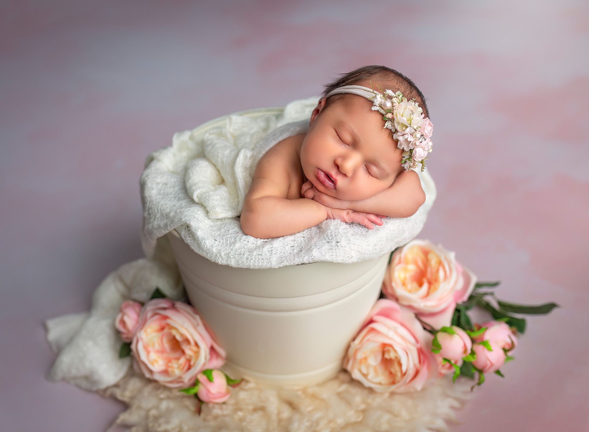 newborn baby sleeping in a bucket with pink roses Newborn Maternity Photographer