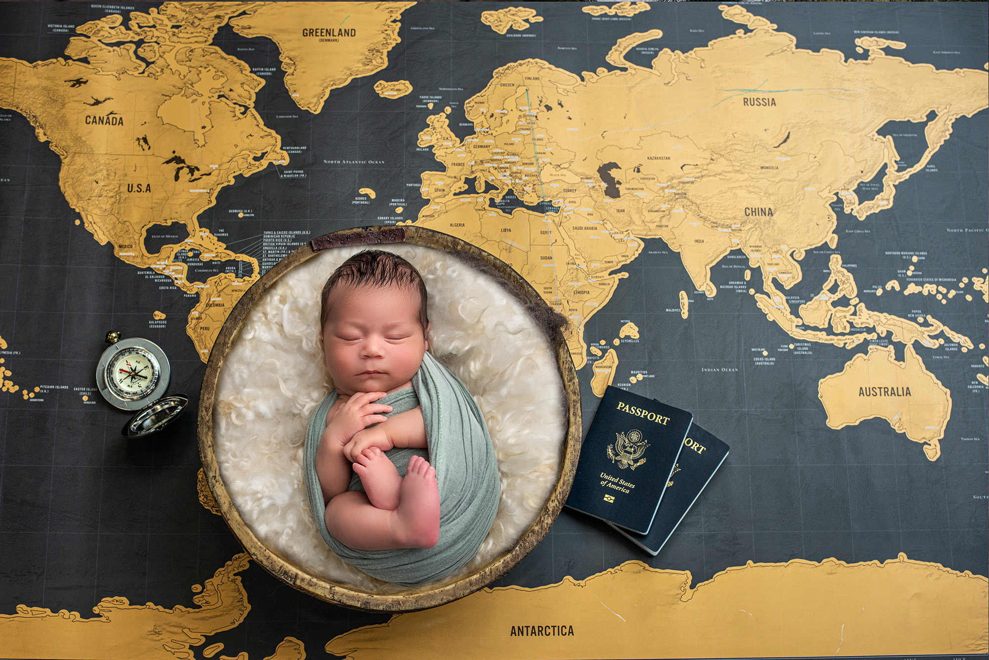 Newborn photos with Thai Culture newborn baby boy asleep in bowl surrounded by world map and passports