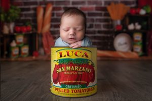 newborn baby sleeping in a can of Italian tomatoes