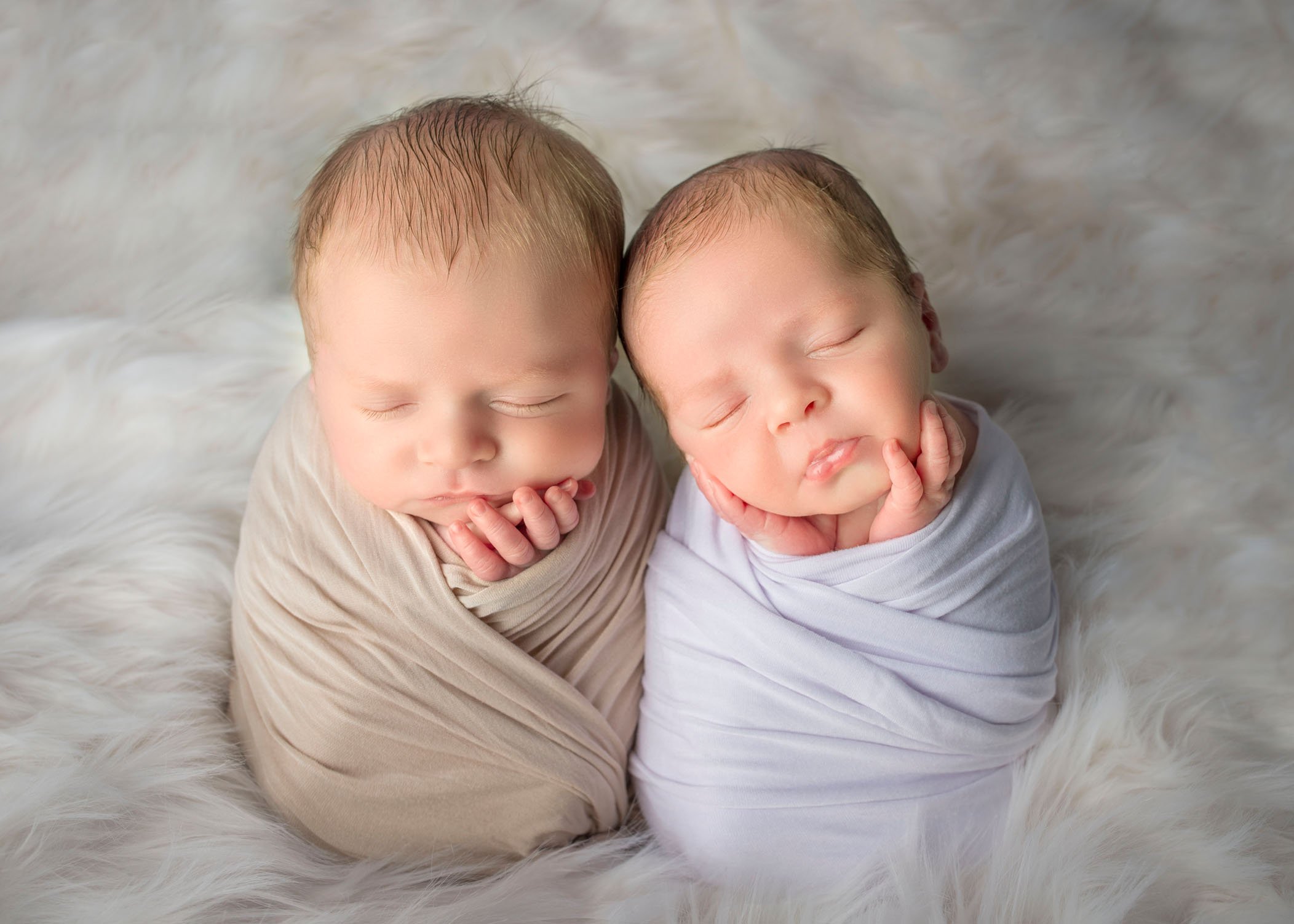 twin newborns sleeping in potato sack pose together